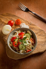 quinoa salad with tomatoes pepper cucumber onion and mint leaf
