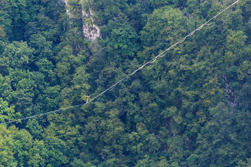 A man walks confidently along the highline.