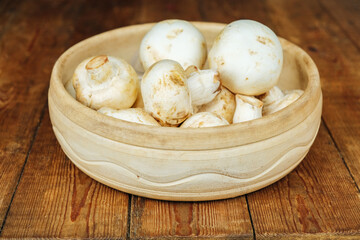 Large mushrooms. Mushrooms on a wooden background, cooking fresh mushrooms.