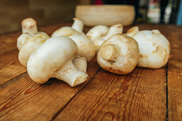 Large mushrooms. Mushrooms on a wooden background, cooking fresh mushrooms.