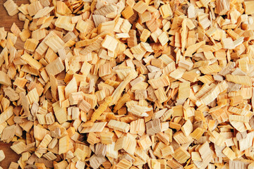 A pile of wood chips close-up, top view. Waste from the woodworking industry, wood chips for smoking.