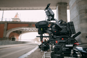 Professional film and video camera on the set. Shooting shift, equipment and group. Modern photography technique.