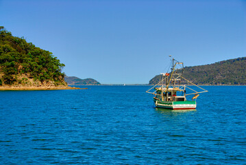 A fishing boat at anchor in Brisk Bay on a clear sunny summer day on the east coast of Australia in Patonga, New South Wales.