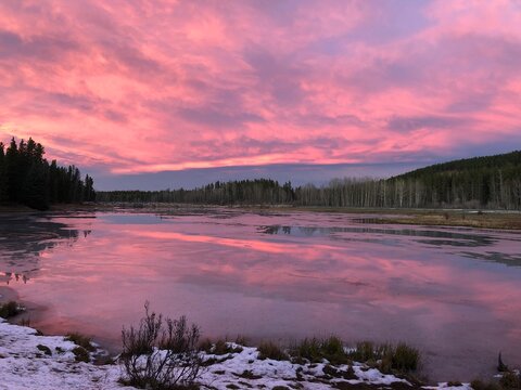 Red skies during sunset over Mclean Pond near Bragg Creek, Calgary, Alberta. Popular fishing pond in Kananaskis Country in Southern Alberta.