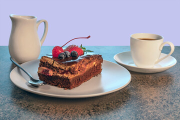a piece of delicious homemade cake on a plate and a cup of tea on a saucer on a wooden kitchen table