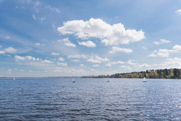 Blue sky and lake with small sailing boats