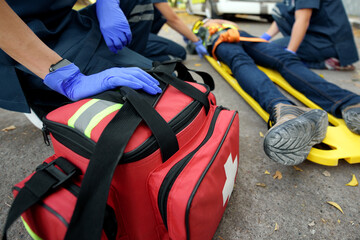 Emergency Medical First aid kit bags of first aid team service for an accident in work of worker loss of function in limbs, First aid training to transfer patient © KL 1981