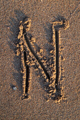 english letters written in the sand