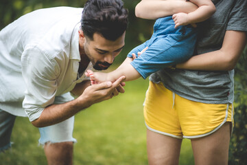 family person concept, father and baby child joy playing in the outdoor nature grass flower garden, having fun and happy smiling, childhood and parent love together in summer at home, Father’s Day