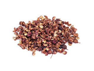 pile of dried pink sichuan pepper closeup on white