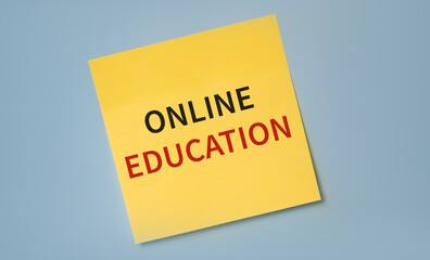 text online education written on a sticker against blue background. Never stop learning. Motivation