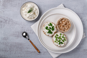 Curd sandwiches with fresh herbs. Crispbread toast with cottage cheese and green herbs. Concept proper snack.