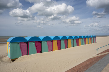 sandy beach and colorful bathhouse in Dunkirk, France