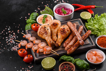 Composition of sausages, chicken, pork and shrimp prepared on grill, as well as vegetables prepared on grill with spices and herbs