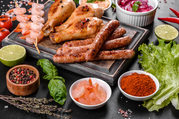Composition of sausages, chicken, pork and shrimp prepared on grill, as well as vegetables prepared on grill with spices and herbs