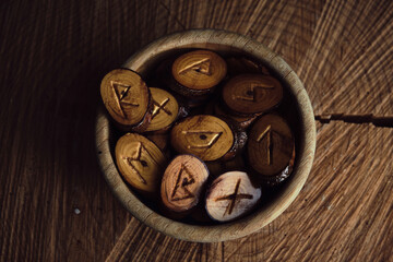 homemade wooden runes on a dark background
