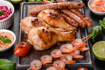 Composition of sausages, chicken, pork and shrimp prepared on grill, as well as vegetables prepared on grill with spices and herbs
