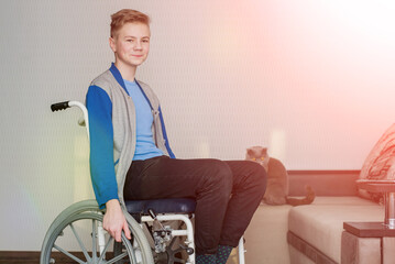 teen boy student sitting in a wheelchair at home.