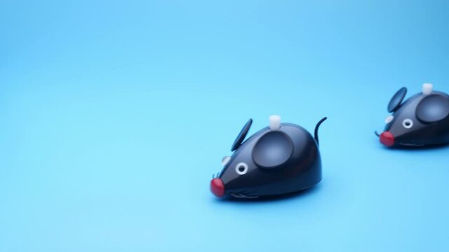 Clockwork mice runs on a blue background. Seamless loop.