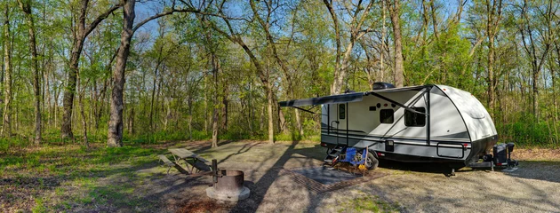 Zelfklevend Fotobehang Travel trailer camping in the woods at starved rock state park illinois © dvande