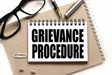 Grievance Procedures, notepad on notepad, text on white notepad on white background