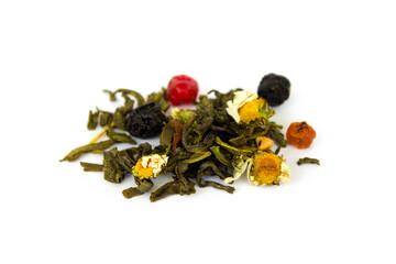 a handful of dry tea from leaves, fruits and flowers on a white isolated background close-up