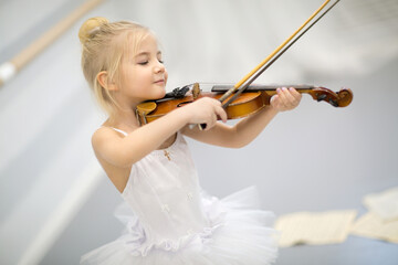 young ballerina playing the violin