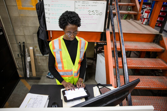 Supervisor using digital tablet in distribution warehouse