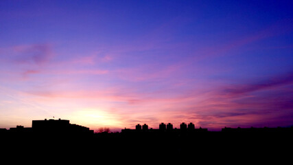 sky during sunset and dawn over the city residential development. vertical landscape.