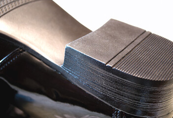 the heel of a man's boot. patent leather boot sole. White background
