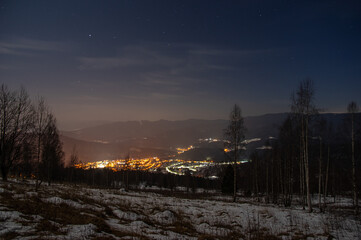 Fototapeta na wymiar Beautiful panorama of the night city in the mountains in winter