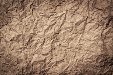 Background of old crumpled paper. Brown textured background