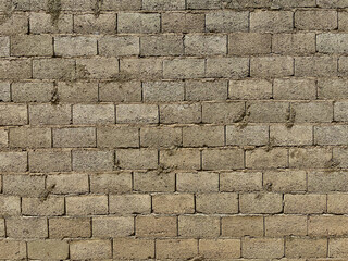 Rough wall with cement and concrete blocks outside.