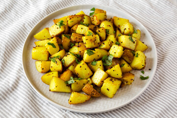 Homemade Roasted Potatoes with Mustard Seeds on a Plate, side view.