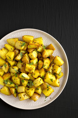 Homemade Roasted Potatoes with Mustard Seeds on a Plate, top view. Flat lay, overhead, from above. Space for text.