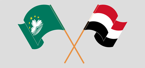 Crossed and waving flags of Macau and Yemen