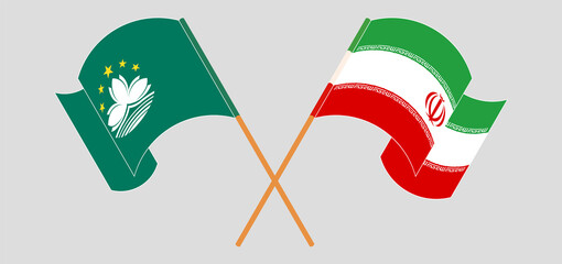 Crossed and waving flags of Macau and Iran