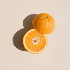 Sliced orange on bright yellow background. Minimal summer concept. Fruit flat lay.