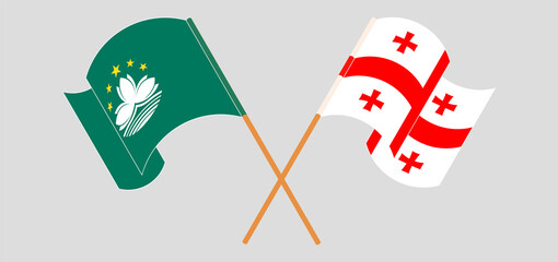 Crossed and waving flags of Macau and Georgia