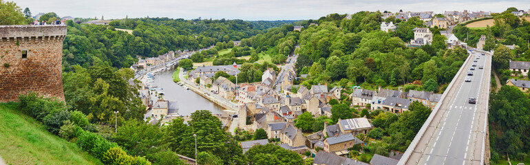 Fototapeta na wymiar Panoramic view of the Port of Dinan and the Rance river from the Promenade of Duchesse Anne at the Jardin Anglais