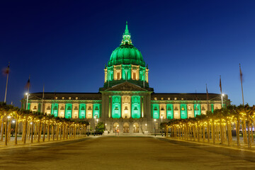 Fototapeta na wymiar Blue Hour over San Francisco City Hall Lit in Yellow and Green in Celebration of Mother's Day.