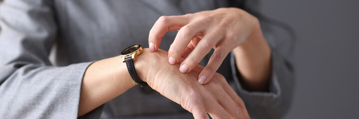 Woman scratches her hand with her nails