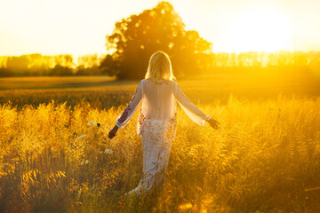 Beautiful blond women in the natural fields in the light of sunshine. Best for illustration of beauty and freedom