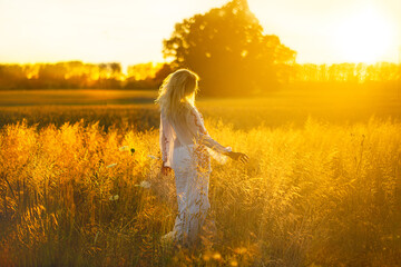 Beautiful blond women in the natural fields in the light of sunshine. Best for illustration of beauty and freedom
