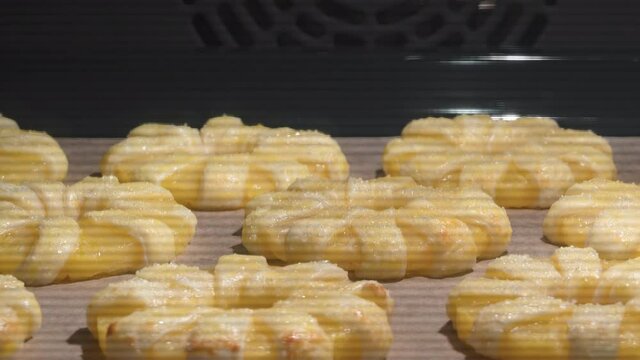 4K Time Lapse of baking process of pineapple puff pastry rings in oven, home made. Time-lapse video of sweet puff pastry cakes with pineapples baked in oven.