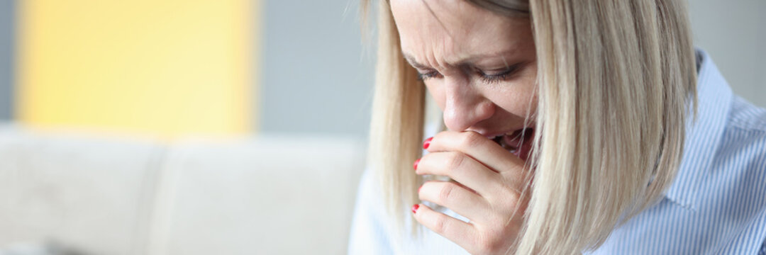 Woman cries and looks at smartphone screen - Powered by Adobe