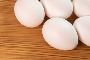 White eggs on the raw pasta