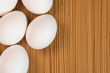 White eggs on the raw pasta