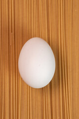 White egg on the raw pasta
