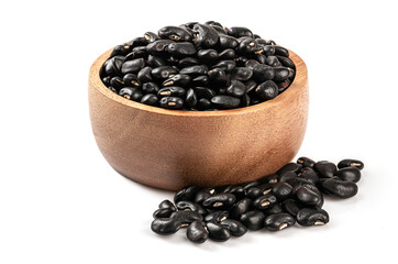 Black beans in a wooden bowl on white background.